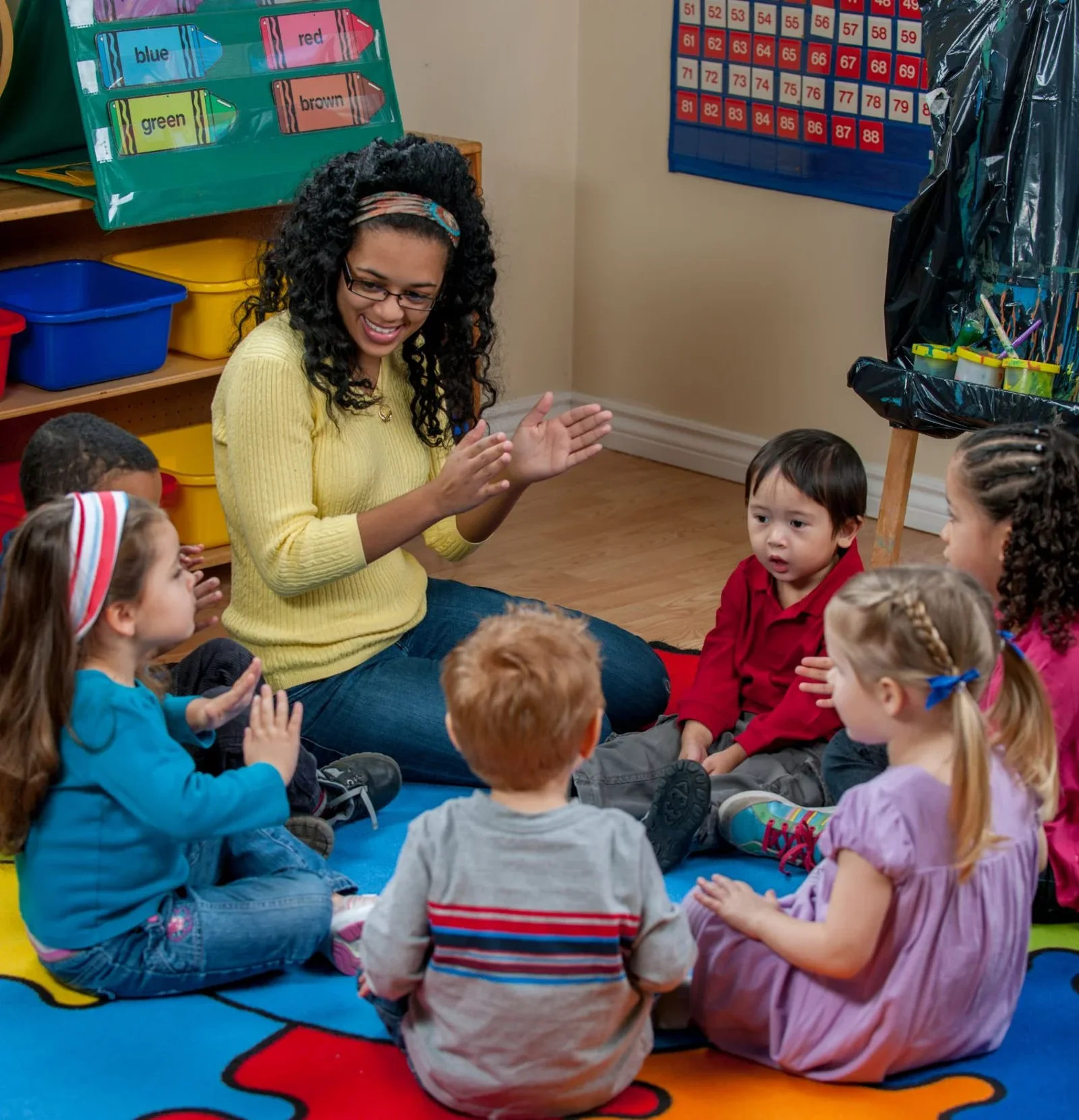 Teacher leading circle time with a group of young children at Primary Prep.